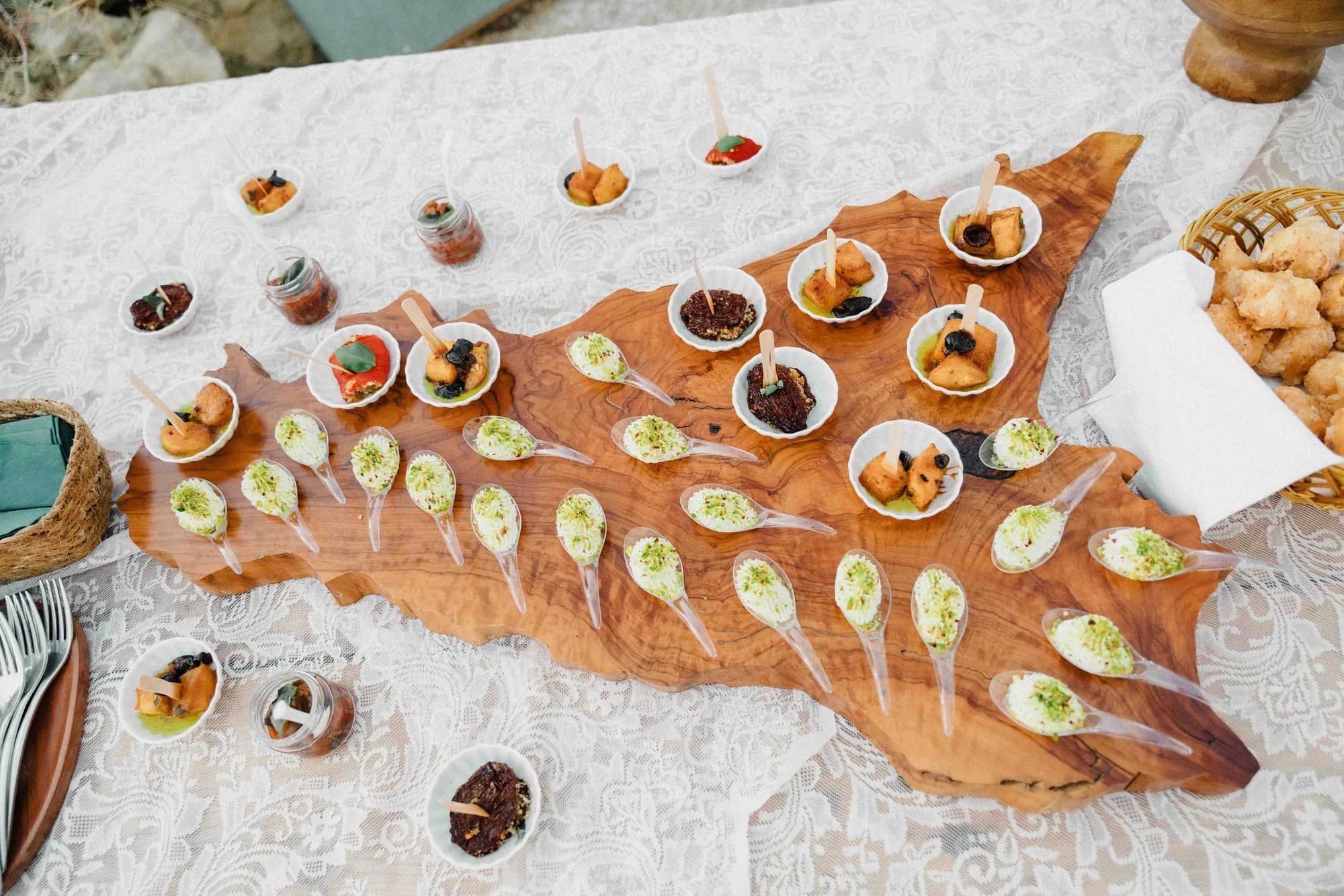 Sicilian tasting plates laid out on a board carved in the shape of the island