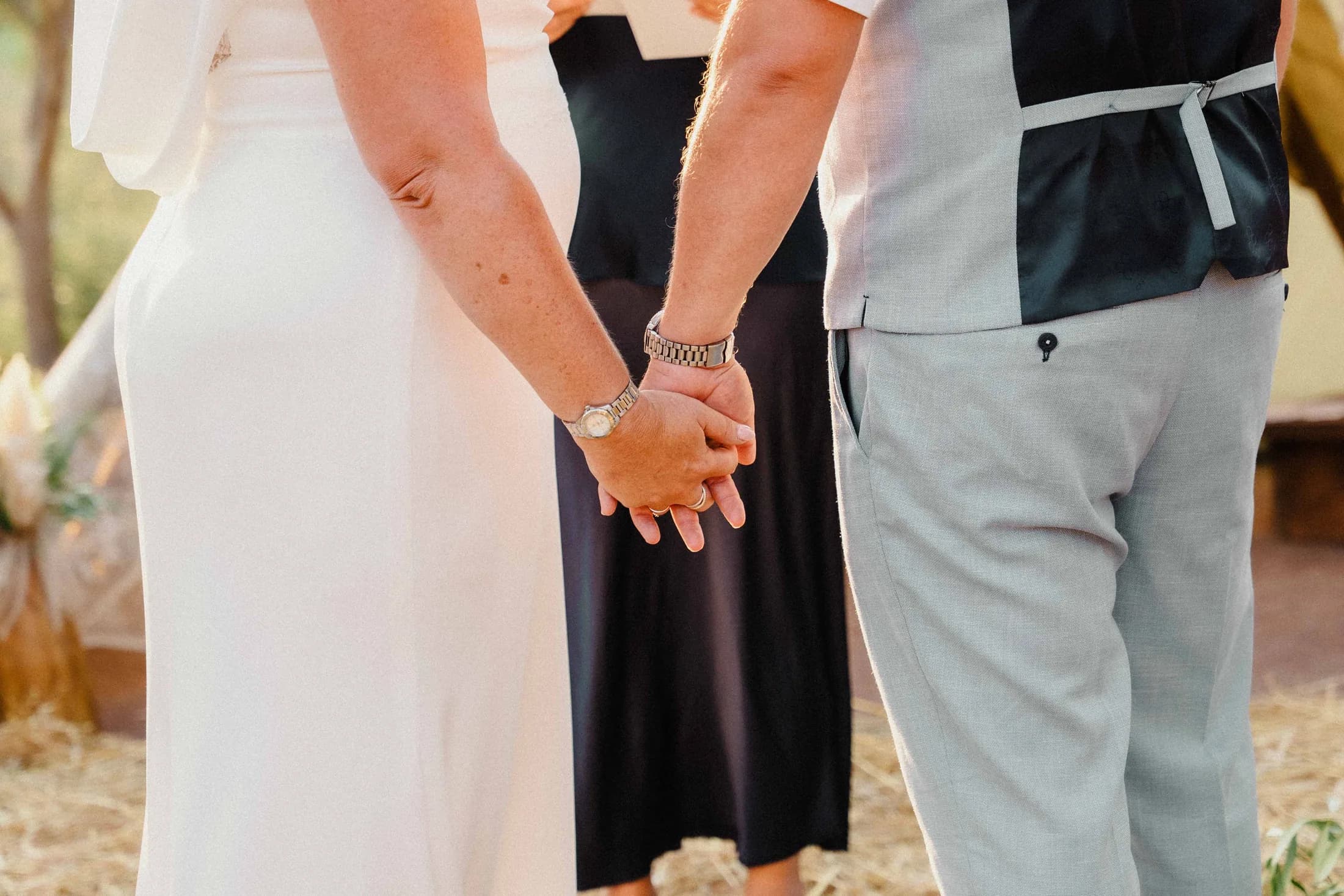 Two hands held tightly together during the ceremony