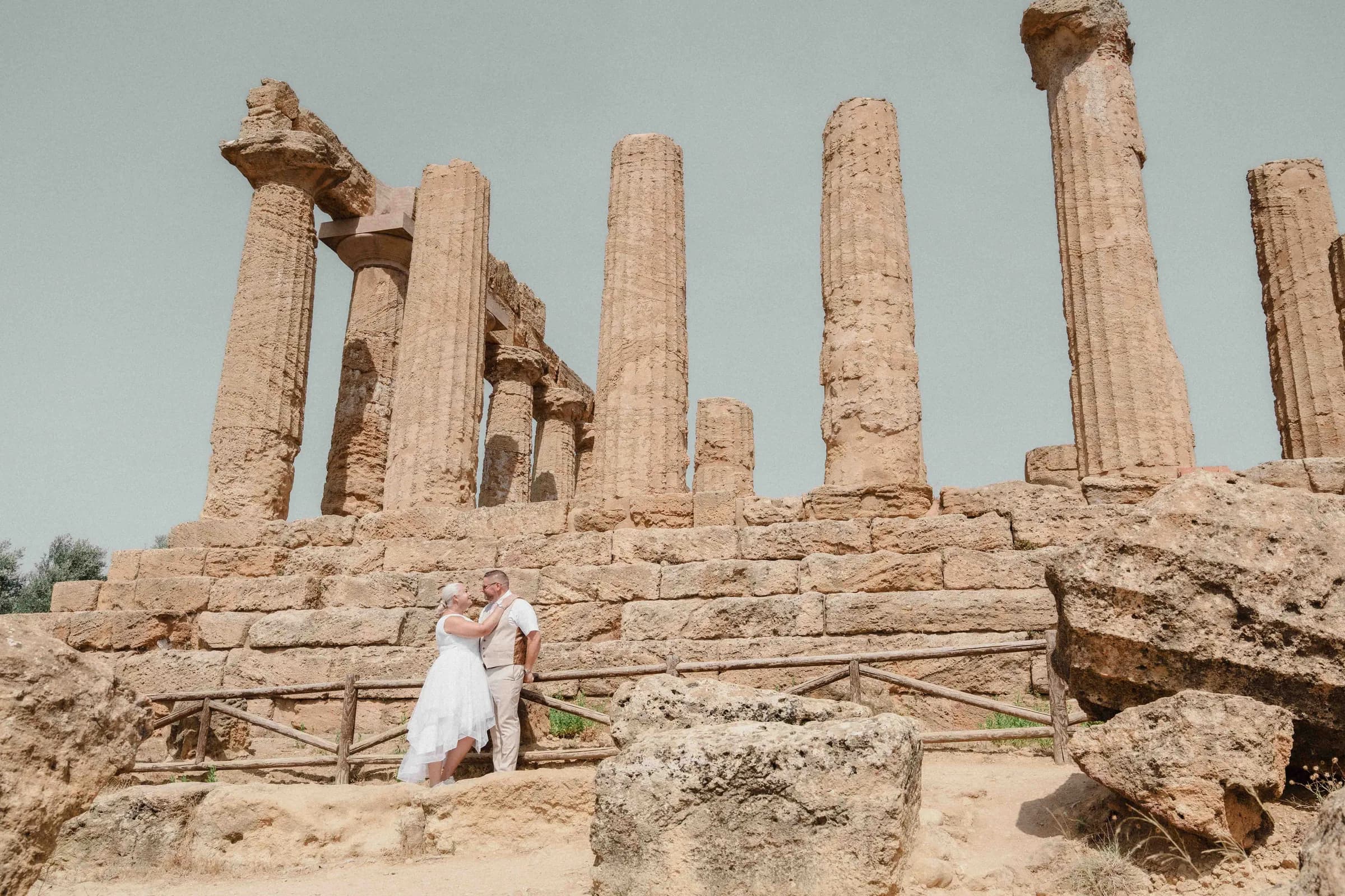 A bride on the temple steps, the Greek colonnade rising behind her